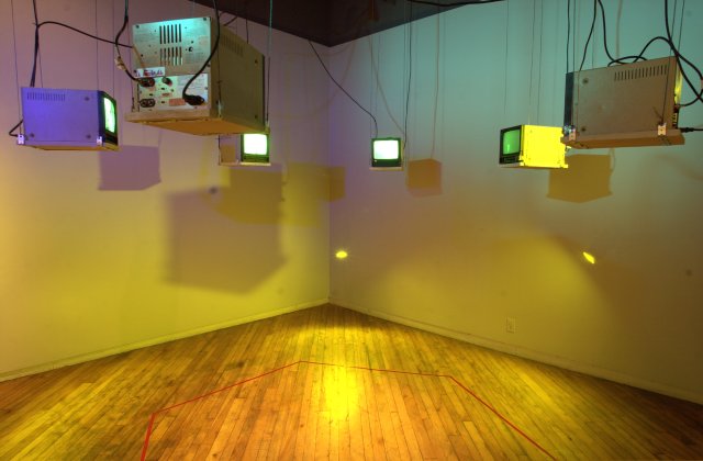 Six television receivers hanging from the ceiling in a hexagonal
          arrangement, providing video output from cameras concealed behind
          the six walls of the triage/observation room.